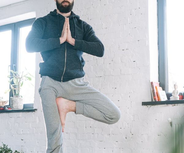 Focused man meditating after a workout session, calm expression.